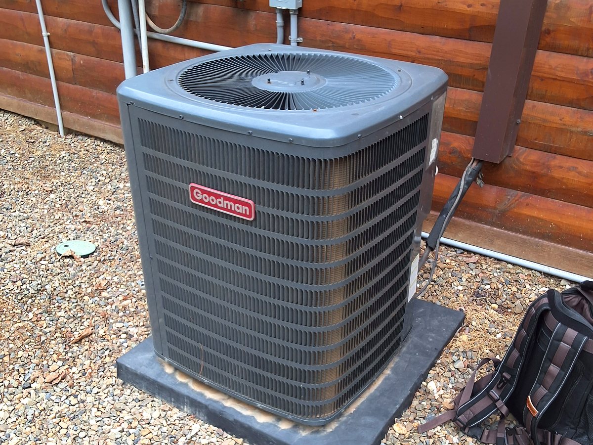 Goodman condenser serviced at a log cabin